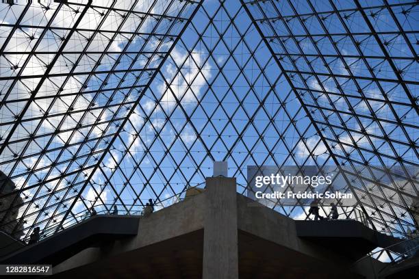 The Louvre Pyramid , designed by the architect I. M. Pei, surrounded by three smaller pyramids, in the main courtyard of the Louvre Palace in Paris...