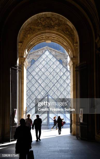 The Louvre Pyramid , designed by the architect I. M. Pei, surrounded by three smaller pyramids, in the main courtyard of the Louvre Palace in Paris...