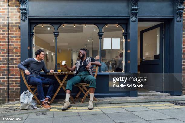 enjoying a coffee together - sidewalk cafe stock pictures, royalty-free photos & images