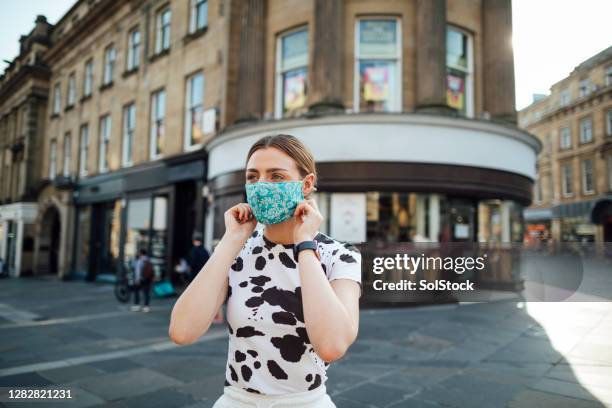 adjusting her face mask - empty street stock pictures, royalty-free photos & images