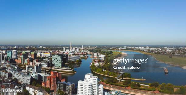 aerial view of düsseldorf media harbor with rhine river - riverbank stock pictures, royalty-free photos & images
