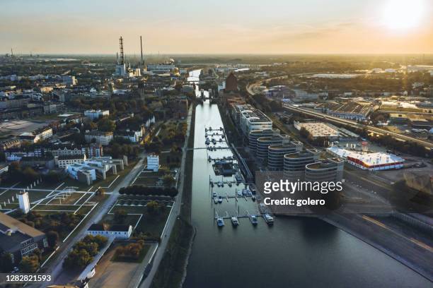 drone view over old harbor with marina of duisburg at sunset - duisburg stock pictures, royalty-free photos & images