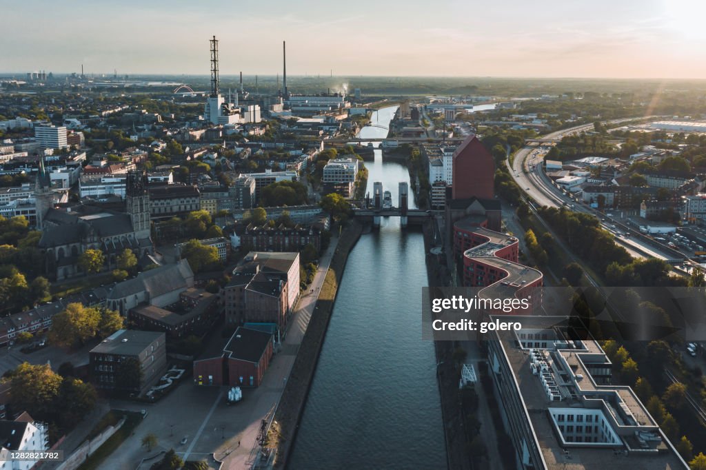 Drone view over canal in old harbor of Duisburg at sunset