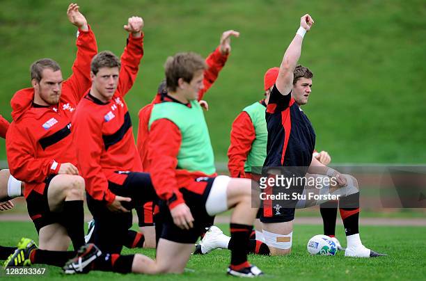 Flanker Dan Lydiate stretches with teammates during a Wales IRB Rugby World Cup 2011 training session at Newtown Park on October 6, 2011 in...