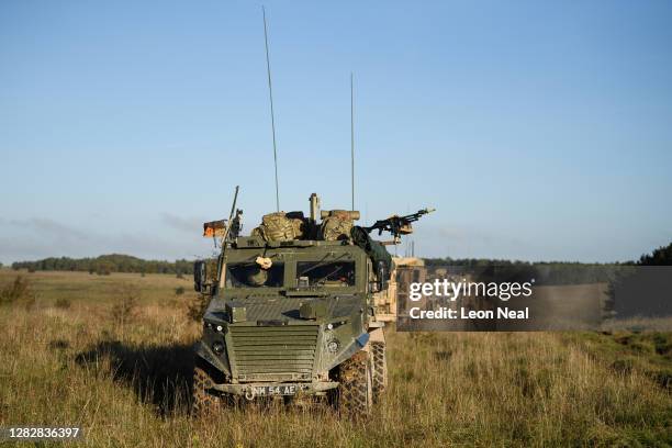 Soldiers from the Royal Anglian Regiment travel in a convoy of Foxhound and Mastiff armoured vehicles as they approach the location of a reported...