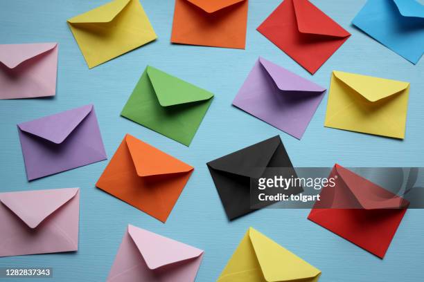 colorful envelopes on blue background - colourful letters stock pictures, royalty-free photos & images