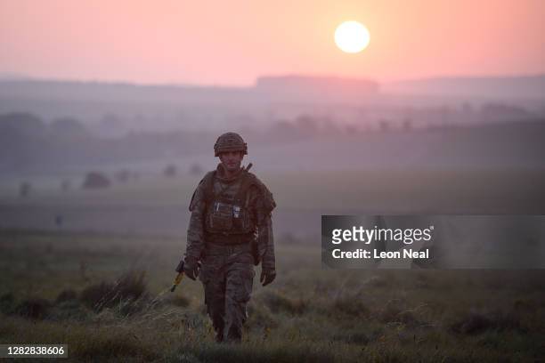 Soldier from the US Task Group patrols the perimeter of the camp just after sunrise during a Mission Rehearsal Exercise ahead of deployment to Mali,...