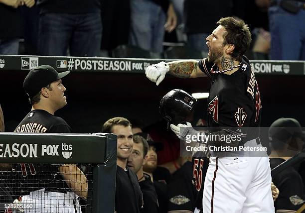 Ryan Roberts of the Arizona Diamondbacks celebrates after hitting a grand slam home run in the first inning against the Milwaukee Brewers in Game...