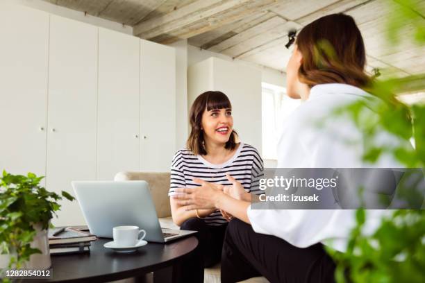 young women working in the creative office - green sofa stock pictures, royalty-free photos & images