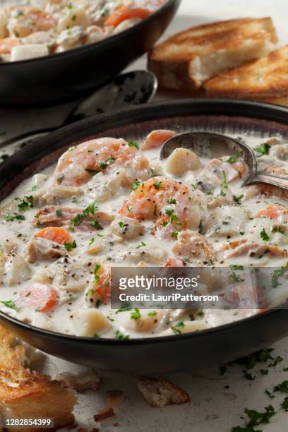 seafood chowder with shrimp, bay scallops, clams and salmon - new england clam chowder stock pictures, royalty-free photos & images