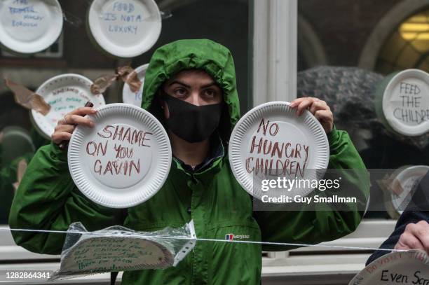 Paper plates are attached to the Department for Education building by members of the National Education Union and their supporters during a protest...