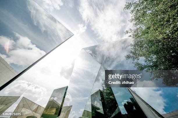 urban landscape reflected by polyhedral glass - glass material stock pictures, royalty-free photos & images