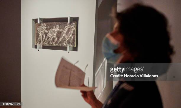 Curator Luísa Sampaio wears a protective mask while briefing journalists on a press visit to the "René Lalique e a Idade do Vidro, Arte e Indústria"...