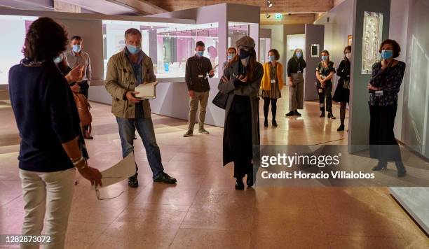 Curator Luísa Sampaio and visiting journalists wear protective masks on a press visit to the "René Lalique e a Idade do Vidro, Arte e Indústria"...