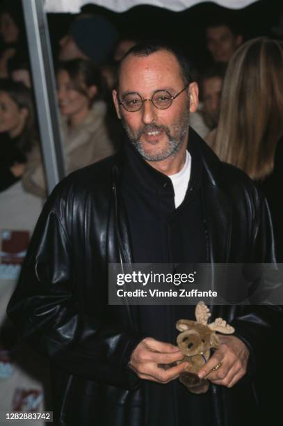 French actor of Andalusian Spanish descent Jean Reno, holding a soft toy of a moose, attends the 2000 MTV European Music Awards, held at the Ericsson...
