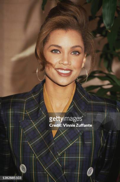 American singer and actress Vanessa Williams, wearing a green and blue check jacket, attends the Soul Train Awards nominations celebration, location...