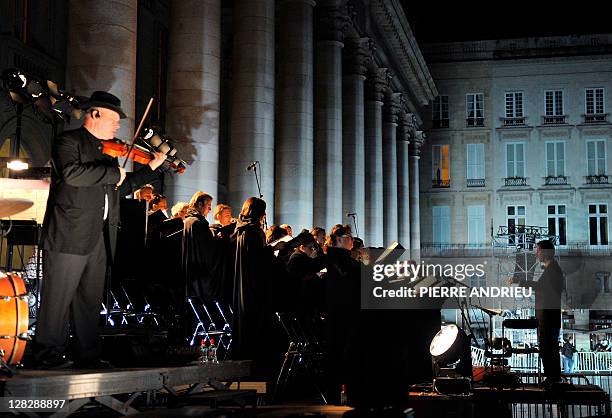 Singers and musicians of the show "Rosso Bordeaux" with Italian artist Pippo Delbono, attend a rehearsal on October 5, 2011 place de la Comédie in...