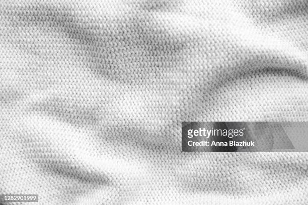 warm knitted wool white sweater close up, textile abstract winter background - wool stock pictures, royalty-free photos & images