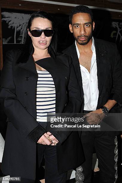 Beatrice Dalle and Ryan Leslie attend the John Galliano Ready to Wear Spring / Summer 2012 show during Paris Fashion Week on October 2, 2011 in...