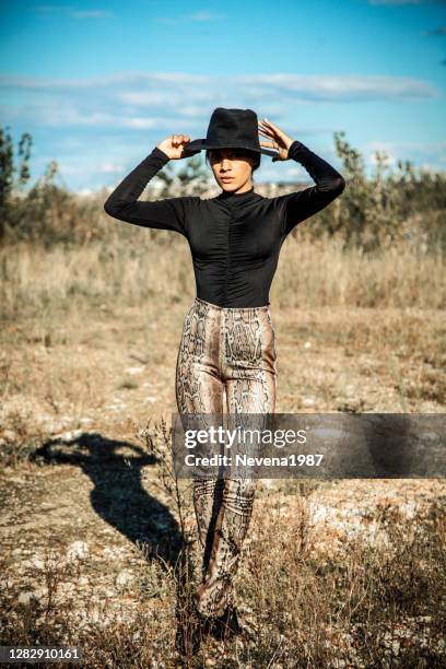 portrait of a young woman with shadows texture on the face in a meadow - black snakeskin stock pictures, royalty-free photos & images