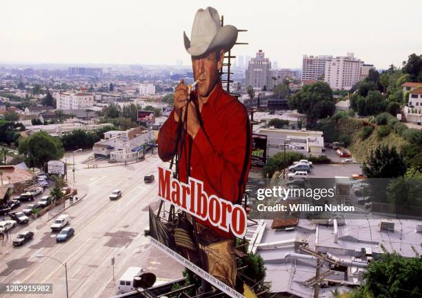 Billboard for Marlboro Cigarettes with the iconic Marlboro Man on Sunset Boulevard circa 1995 in Los Angeles, California. The Marlboro Man was...