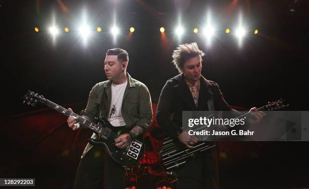 GuitaristS Zacky Vengeance and Synyster Gates of Avenged Sevenfold perform at Comfort Dental Amphitheatre on October 5, 2011 in Englewood, Colorado.