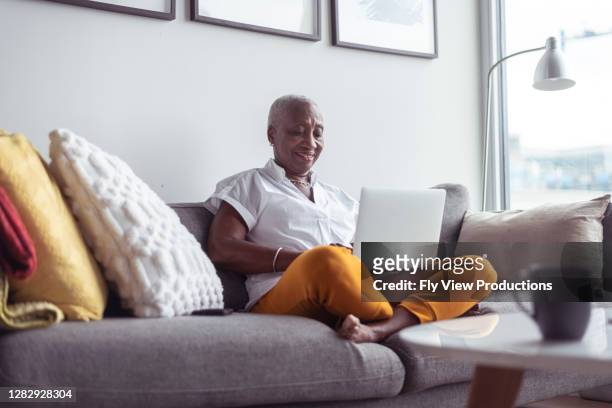 senior business woman working from home - using computer stock pictures, royalty-free photos & images