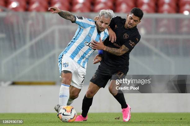 Franco Mussis of Atlético Tucumán competes for the ball with Federico Martínez of Independiente during a second round match of Copa CONMEBOL...