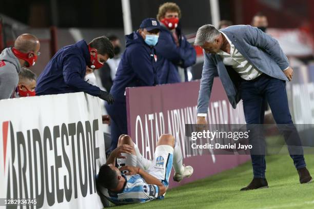 Lucas Pusineri coach of Independiente helps Ramiro Carrera of Atlético Tucumán during a second round match of Copa CONMEBOL Sudamericana 2020 between...