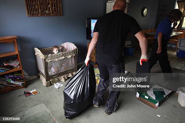 Chase Milam watches as an eviction team removes household goods during a home foreclosure eviction on October 5, 2011 in Milliken, Colorado. His...