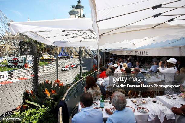 Diners at the Hotel de Paris restaurant watch Italian Formula One Toyota driver Jarno Trulli drive his Toyota TF108 through Casino Square during...