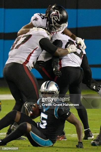 Grady Jarrett, Steven Means and Deion Jones of the Atlanta Falcons celebrates sacking Teddy Bridgewater of the Carolina Panthers during the fourth...