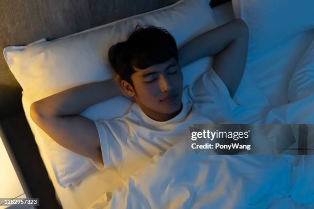 asian man sleep well - bedtime stock pictures, royalty-free photos & images