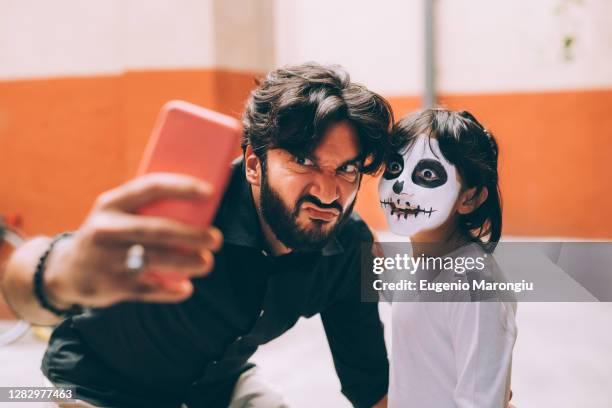 girl and father taking halloween selfie - man face paint stock pictures, royalty-free photos & images