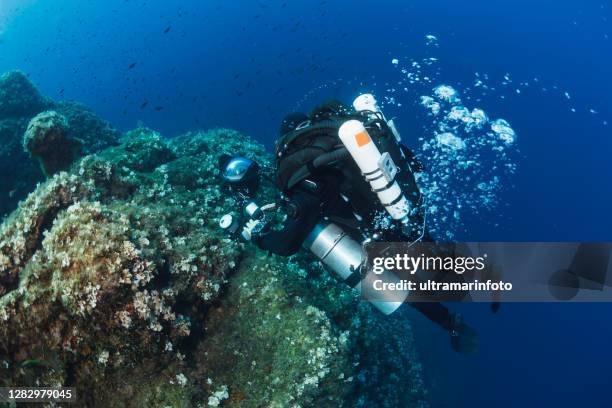 underwater photographer - technical diving scuba diver used closed circuit rebreather exploring and enjoying  sea life water sports techdive scuba diver point of view  deep in sea sea life mediterranean sea - photographer seascape stock pictures, royalty-free photos & images