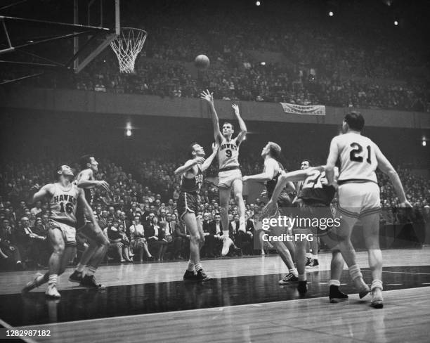 American basketball player Bob Pettit, #9 for St Louis Hawks , in action during a game against Boston Celtics, US circa 1957.