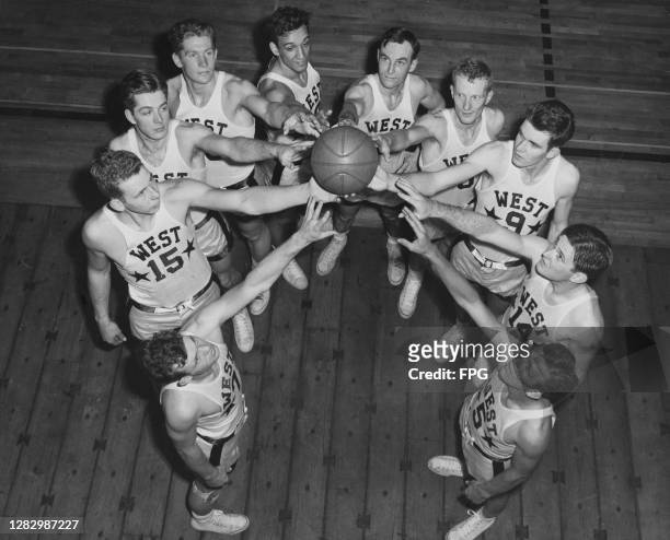 The 1949 NCAA Basketball All-Star West Team gathered around a ball, US, 1949. They are Vern Gardner, , Bill Evans , Paul Courty , Cliff Crandall ,...