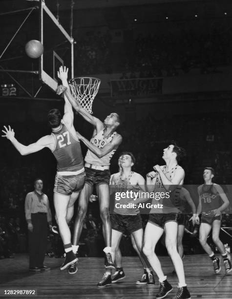 American basketball player Ben Bluitt of Loyola foils basket attempt by Wallace Jones of Kentucky Wildcats during the National Invitation Tournaments...