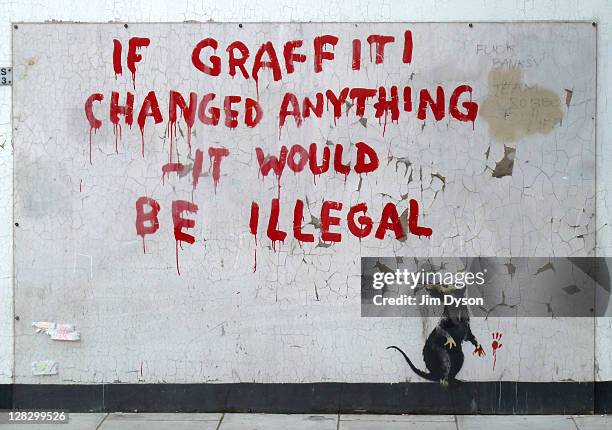 New stencil and spray paint artwork, by guerilla graffiti artist Banksy, appears in Fitzrovia, October 6, 2011 in London, England. The piece, that...