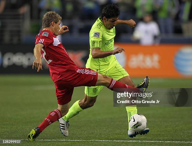 Leonardo Gonzalez of the Seattle Sounders FC dribbles Logan Pause of the Chicago Fire during the 2011 Lamar Hunt US Open Cup Final at CenturyLink...
