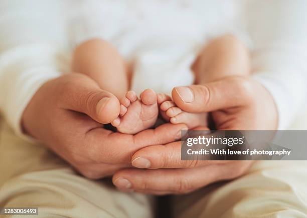 father with a newborn baby beautiful photos of a young adult man holding little son, paternity leave - parental leave stockfoto's en -beelden