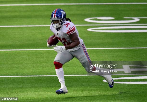 Devonta Freeman of the New York Giants runs during a 17-9 Los Angeles Rams win at SoFi Stadium on October 04, 2020 in Inglewood, California.