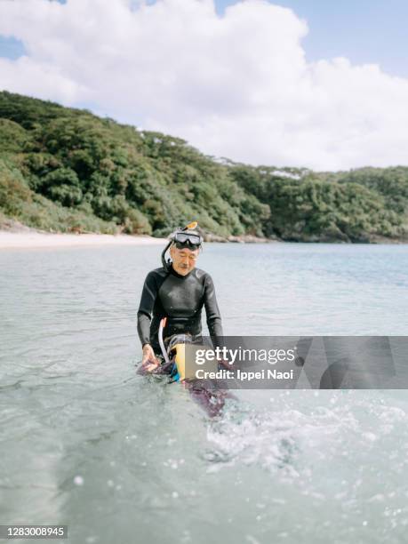 grandfather teaching granddaughter how to snorkel - okinawa islands stock pictures, royalty-free photos & images