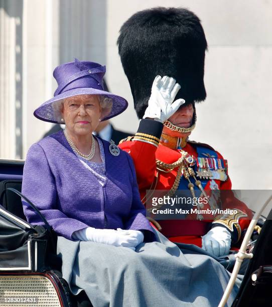 Queen Elizabeth II and Prince Philip, Duke of Edinburgh travel down The Mall in a horse drawn carriage during the annual Trooping the Colour Parade...