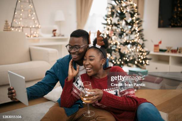 happy african american couple celebrating winter holidays together - happy holidays family stock pictures, royalty-free photos & images