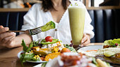 Close up of woman  hand with Broccoli and salad with a Healthy food of salad and detox drink ,Healthy lifestyle Concept.