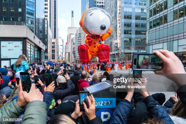 snoopy astronaut character balloon debuts in the macy's thanksgiving day parade. - thanksgiving parade stock pictures, royalty-free photos & images