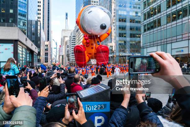 snoopy astronaut character balloon debuts in the macy's thanksgiving day parade. - thanksgiving day stock pictures, royalty-free photos & images