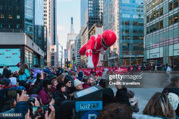 giant red mighty morphin power ranger balloon flown at the annual macy's thanksgiving day parade on columbus circle - thanksgiving parade stock pictures, royalty-free photos & images
