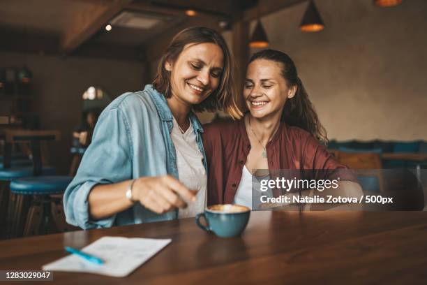 young adult lesbian caucasian couple holding each other in cafe,ko pha ngan,thailand - asian lesbians kiss stock pictures, royalty-free photos & images